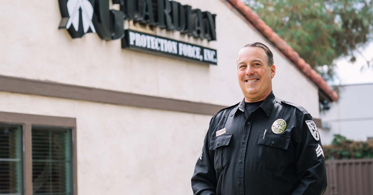 Captain Ed Turner, Director of Uniformed Security Operations for Guardian Protection Force, standing in uniform outside the Guardian Protection Force office.